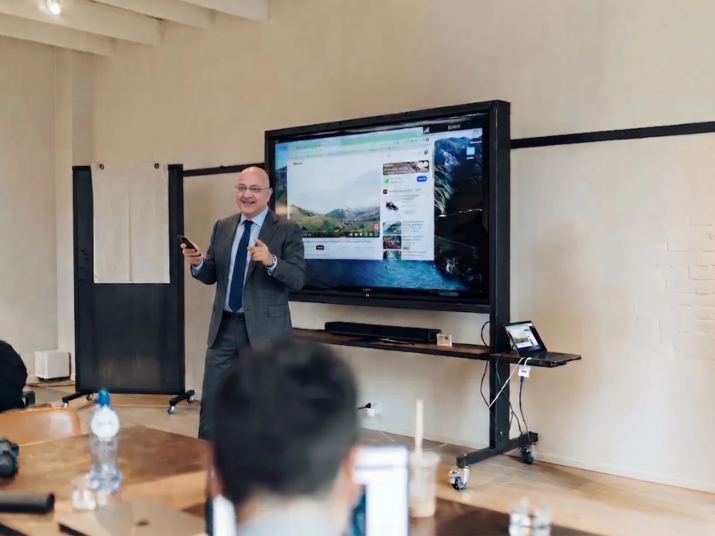 Workshop facilitators leading a professional training session in a modern meeting room