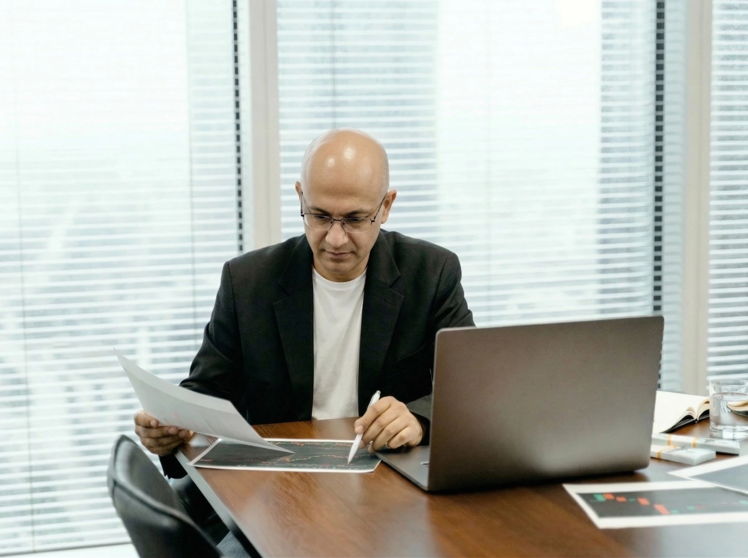Marketing professional reviewing campaign performance charts at a modern office desk